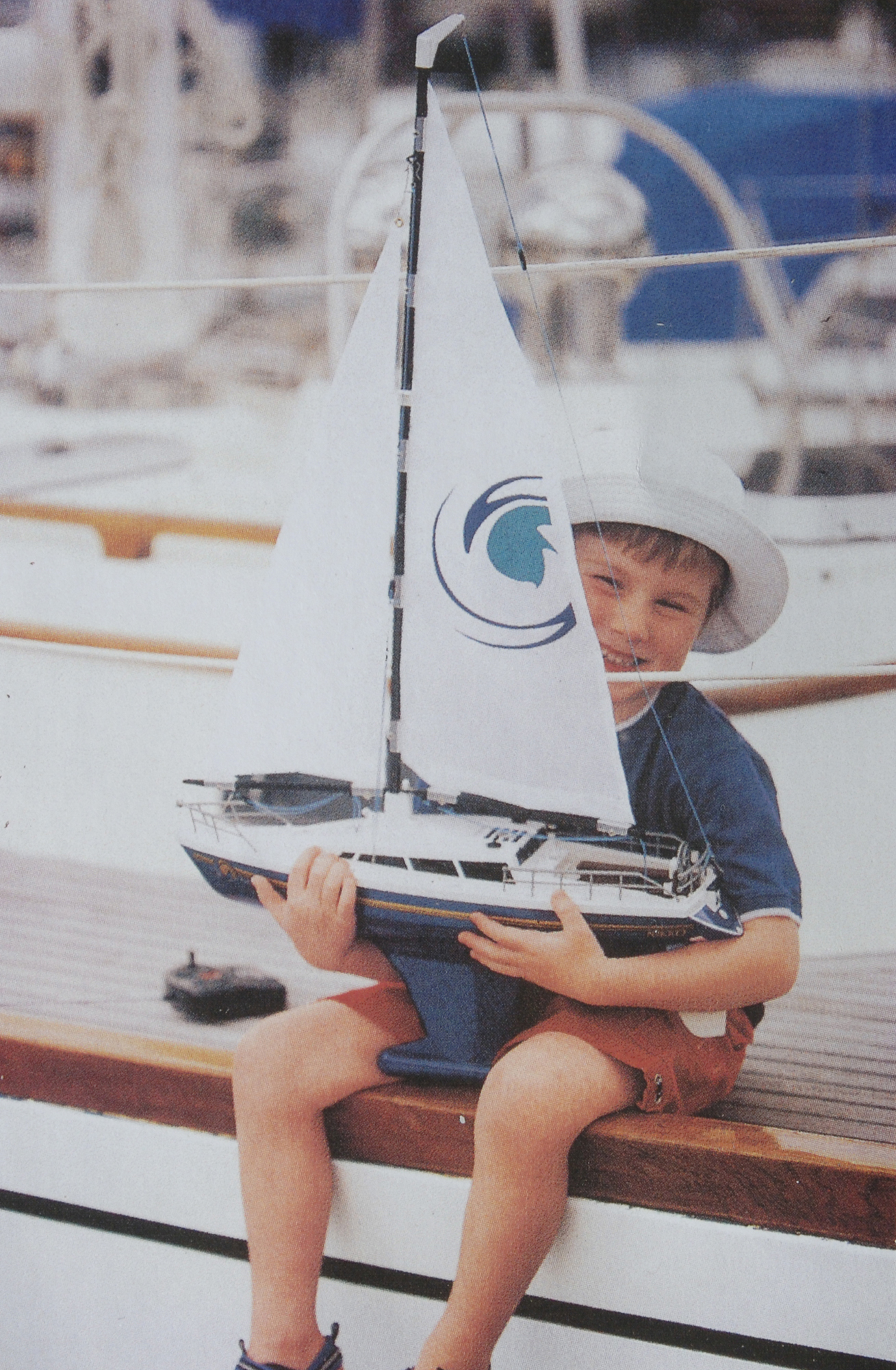 boy with toy yacht